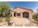 Inviting backyard with covered patios, a stone patio area, and mature desert landscaping at 1214 Country Club Dr, Laughlin, NV 89029