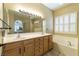 Bathroom featuring double sinks, large mirror and bathtub at 1214 Country Club Dr, Laughlin, NV 89029