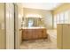 Neutral-toned bathroom featuring a double vanity and soaking tub at 1214 Country Club Dr, Laughlin, NV 89029