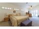 Spacious bedroom with a ceiling fan, natural lighting and furniture at 1214 Country Club Dr, Laughlin, NV 89029