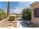Landscaped front yard with desert plants, gravel, walkway, and a view of neighboring houses at 1214 Country Club Dr, Laughlin, NV 89029