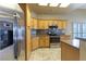 Well-lit kitchen featuring stainless steel appliances, tile flooring, and ample cabinet space at 1214 Country Club Dr, Laughlin, NV 89029
