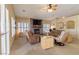 Bright living room featuring a stacked stone fireplace, ceiling fan and comfortable seating at 1214 Country Club Dr, Laughlin, NV 89029
