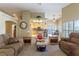 Open-concept living room and kitchen with modern lighting, comfortable furniture and neutral color palette at 1214 Country Club Dr, Laughlin, NV 89029