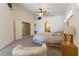 Bright primary bedroom featuring a ceiling fan and sitting area at 1214 Country Club Dr, Laughlin, NV 89029