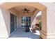 Relaxing outdoor patio with a ceiling fan, a cozy wicker bench, and sliding glass doors at 1214 Country Club Dr, Laughlin, NV 89029