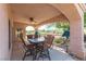 Relaxing outdoor patio with comfortable seating, a ceiling fan, and views of the lush backyard at 1214 Country Club Dr, Laughlin, NV 89029