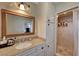 Well-lit bathroom with a granite countertop, vanity, and a tiled walk-in shower at 2213 W Oakey Blvd, Las Vegas, NV 89102