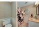 Bathroom featuring toilet, vanity with granite countertop, and shower with patterned curtain at 2213 W Oakey Blvd, Las Vegas, NV 89102