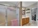 Bathroom boasts a glass-enclosed shower and a view of double sinks with cabinets and a framed mirror at 2213 W Oakey Blvd, Las Vegas, NV 89102