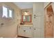 Well-lit bathroom with a granite countertop, vanity, and a tiled walk-in shower at 2213 W Oakey Blvd, Las Vegas, NV 89102