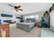 Bedroom features a ceiling fan, a bed with a tufted headboard, carpeted floors, and a white brick fireplace at 2213 W Oakey Blvd, Las Vegas, NV 89102