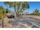 Long driveway with unique brickwork leads to a charming home with mature trees at 2213 W Oakey Blvd, Las Vegas, NV 89102