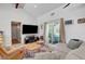 Well-lit living room featuring tile floors, a comfortable sofa, and a view to the backyard at 2213 W Oakey Blvd, Las Vegas, NV 89102