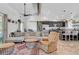 Open-concept living space with vaulted ceilings flows into the adjacent kitchen, with a large couch and sitting chair at 2213 W Oakey Blvd, Las Vegas, NV 89102