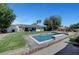 Inviting backyard oasis featuring a sparkling pool, lush greenery, and a well-maintained lawn, perfect for relaxation and recreation at 2213 W Oakey Blvd, Las Vegas, NV 89102