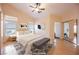 Virtually staged main bedroom with wood floors and mirrored closet doors at 2424 Ping Dr, Henderson, NV 89074