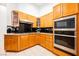 Well-equipped kitchen featuring wood cabinets and granite countertops at 2424 Ping Dr, Henderson, NV 89074