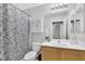 Clean bathroom with shower/tub combo, vanity, and floral shower curtain at 31 E Agate Ave # 205, Las Vegas, NV 89123