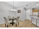 Dining area with a glass-top table and four light-colored chairs at 31 E Agate Ave # 205, Las Vegas, NV 89123