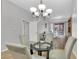 Dining area with glass table and four light-grey chairs at 31 E Agate Ave # 205, Las Vegas, NV 89123