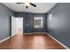 Bedroom with wood floors, a ceiling fan, two windows and blue-grey painted walls at 3665 Bella Legato Ave, North Las Vegas, NV 89081