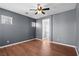 Bedroom features wood floors, gray walls, a ceiling fan and access to the bathroom at 3665 Bella Legato Ave, North Las Vegas, NV 89081