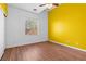 Bedroom with wood floors, ceiling fan, and a large window at 3665 Bella Legato Ave, North Las Vegas, NV 89081