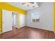 A sunny bedroom featuring wood floors, a closet and a connection to the adjoining bathroom at 3665 Bella Legato Ave, North Las Vegas, NV 89081