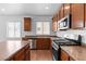 A well-lit kitchen with stainless steel appliances, wood cabinets and a large island at 3665 Bella Legato Ave, North Las Vegas, NV 89081