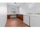 A functional laundry room offering wood floors, built-in cabinetry, and plenty of natural light at 3665 Bella Legato Ave, North Las Vegas, NV 89081