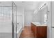 Bright main bathroom featuring a soaking tub, shower, double vanity, and wood-look floors at 3665 Bella Legato Ave, North Las Vegas, NV 89081