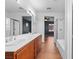 Bright main bathroom featuring a soaking tub, separate shower, double vanity, and wood-look floors at 3665 Bella Legato Ave, North Las Vegas, NV 89081