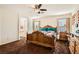 Main bedroom with large wooden bed and ensuite bathroom at 5662 Point Loma Ct, Las Vegas, NV 89122