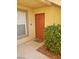 Inviting condo entrance with orange door and landscaping at 2300 E Silverado Ranch Blvd # 1094, Las Vegas, NV 89183