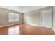 Living room with wood floors, large window, and entry door at 2300 E Silverado Ranch Blvd # 1094, Las Vegas, NV 89183