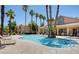 Community pool with lounge chairs and palm trees at 2300 E Silverado Ranch Blvd # 1094, Las Vegas, NV 89183