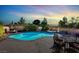 Inviting backyard with sparkling pool, spa, patio furniture, and fire pit at 8639 Tortoise Canyon Ct, Las Vegas, NV 89148