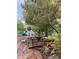 Landscaped backyard with a stone pathway, fountain, and lush greenery at 5740 N Park St, Las Vegas, NV 89149