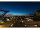 Stunning outdoor space with city views, a built-in bar, and modern landscaping with lighted desert plants at 685 Dragon Peak Dr, Henderson, NV 89012
