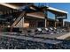 Contemporary home featuring an outdoor staircase and a luxurious patio with modern lounge chairs at 685 Dragon Peak Dr, Henderson, NV 89012