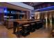 Modern open concept kitchen with a spacious island, seating, and wood cabinetry, perfect for entertaining at 685 Dragon Peak Dr, Henderson, NV 89012