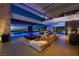 Expansive living room with a large sectional sofa and scenic views, leading to a luxurious outdoor space at 685 Dragon Peak Dr, Henderson, NV 89012