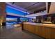 Spacious living area with views of the city skyline, adjacent to a modern kitchen at 685 Dragon Peak Dr, Henderson, NV 89012