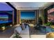 Stylish living room with views of the city skyline, plush seating, and modern decor at 685 Dragon Peak Dr, Henderson, NV 89012