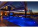 Stunning infinity pool with views of the city lights, integrated seating, and an outdoor lounge at 685 Dragon Peak Dr, Henderson, NV 89012