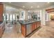 Open kitchen with large center island featuring granite countertop and stainless-steel dishwasher at 48 Panorama Crest Ave, Las Vegas, NV 89135