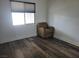 Bedroom featuring hardwood floors and a cozy chair at 1828 Hassett Ave, Las Vegas, NV 89104