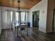 An eat-in dining room with wood ceiling and floors, adjacent to the kitchen and with lots of light at 1828 Hassett Ave, Las Vegas, NV 89104