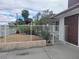 View of the front yard with desert landscaping and a white fence for enhanced curb appeal at 1828 Hassett Ave, Las Vegas, NV 89104